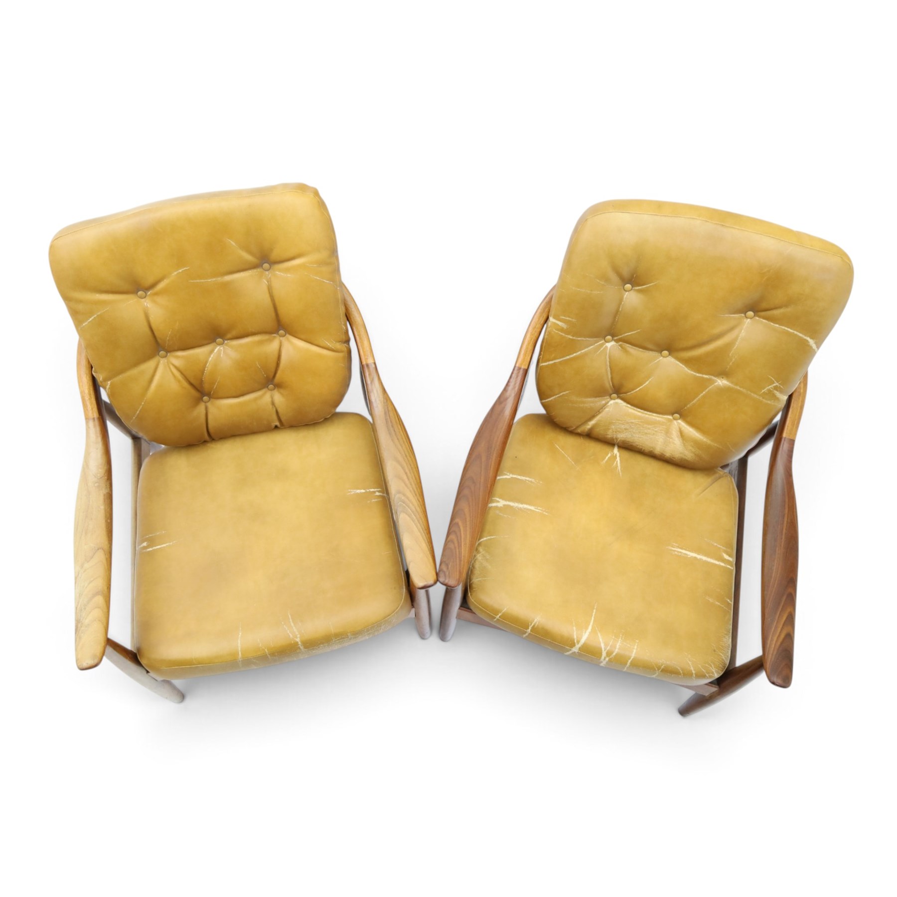 Greaves & Thomas - pair of mid-20th century light elm framed lounge armchairs, with downswept arms and a spindle back, webbing base with makers mark, tan brown leather seat cushions with button back detail
