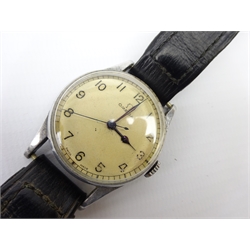 Omega WWII British Military issue stainless steel wristwatch, ref. 2292, the cream dial with Arabic numerals and centre seconds, 17 jewel Bravingtons lever movement, no. 9951614, the back with arrow mark 'H.S8 9775', signed Bravingtons  