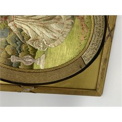 George III silkwork picture, of oval form depicting a female figure in garden setting, within a silkwork border detailed with verse from Robert Burns Bonnie Peg, 'Her air sae sweet, and shape complete, The Queen of Love did never move, Wi' Motion mair enchanting!', and monograms 'FV' and 'SM', in reeded gilt frame and gilt mount, indistinctly inscribed in pencil verso, overall H36cm L30.5cm