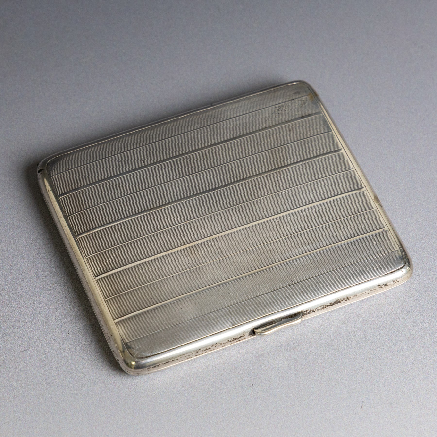 1920s silver cigarette case, of rectangular form with engine turned decoration, hallmarked Alfred Dunhill & Sons, London 1929, H9.5cm