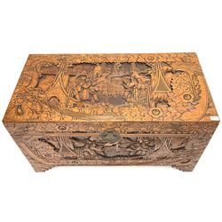 Early 20th century camphor wood chest, heavily carved depicting urban scene, bracket supports 