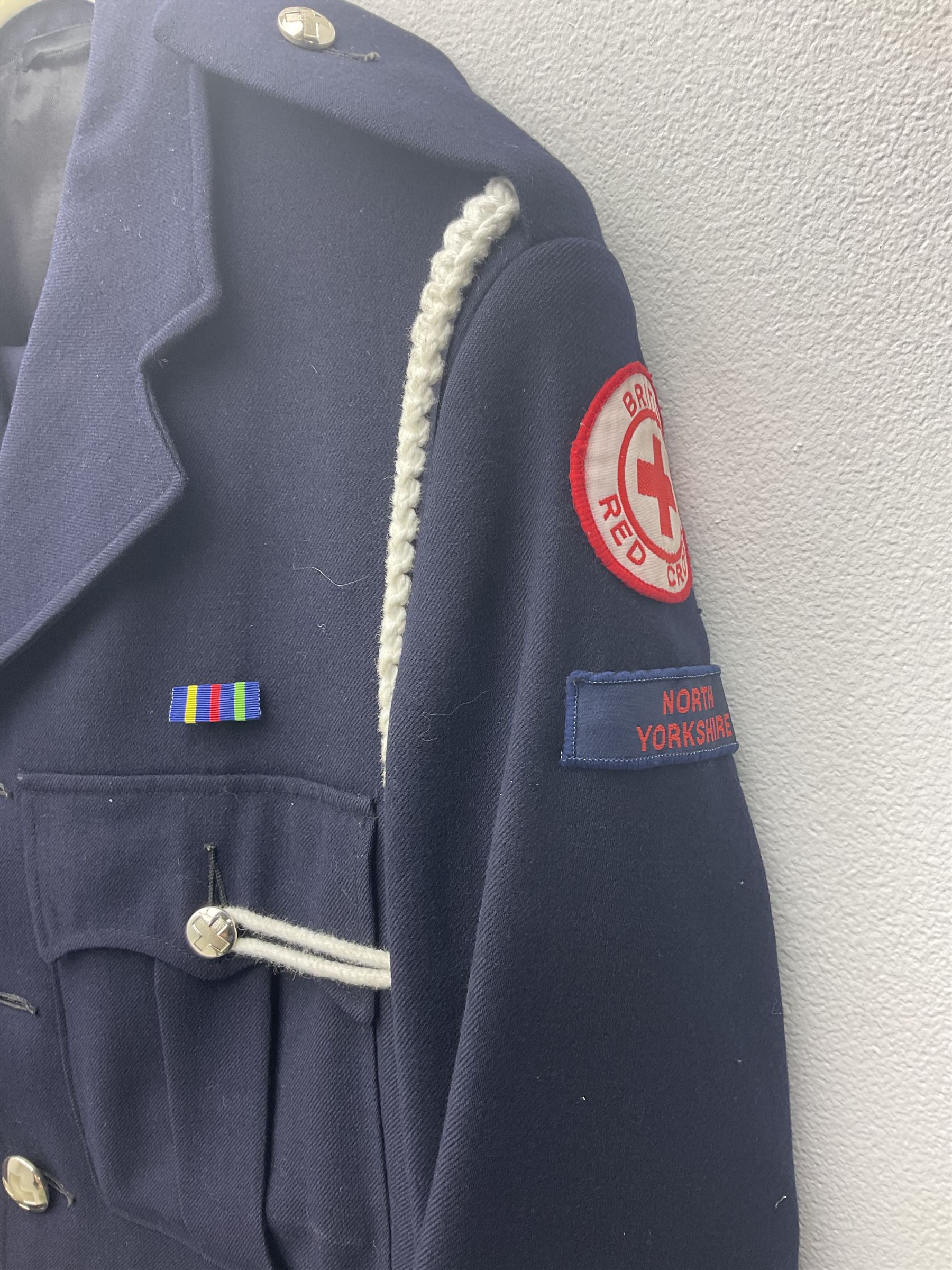 1950s British Red Cross North Yorkshire dress uniform comprising tunic, trousers, greatcoat and visor cap; bears manuscript label '1956 Ware'