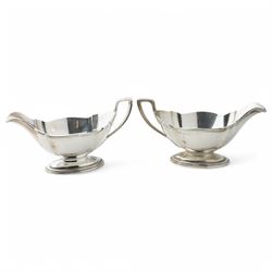 Pair of silver sauce boats with crimped reeded rims, angular handle and on pedestal foot Birmingham 1916 Maker Gorham Manufacturing Co.
