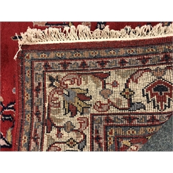  Persian style red ground rug, central medallion (243cm x 171cm)  and a similar red and blue ground rug (294cm x 206cm) (2)  