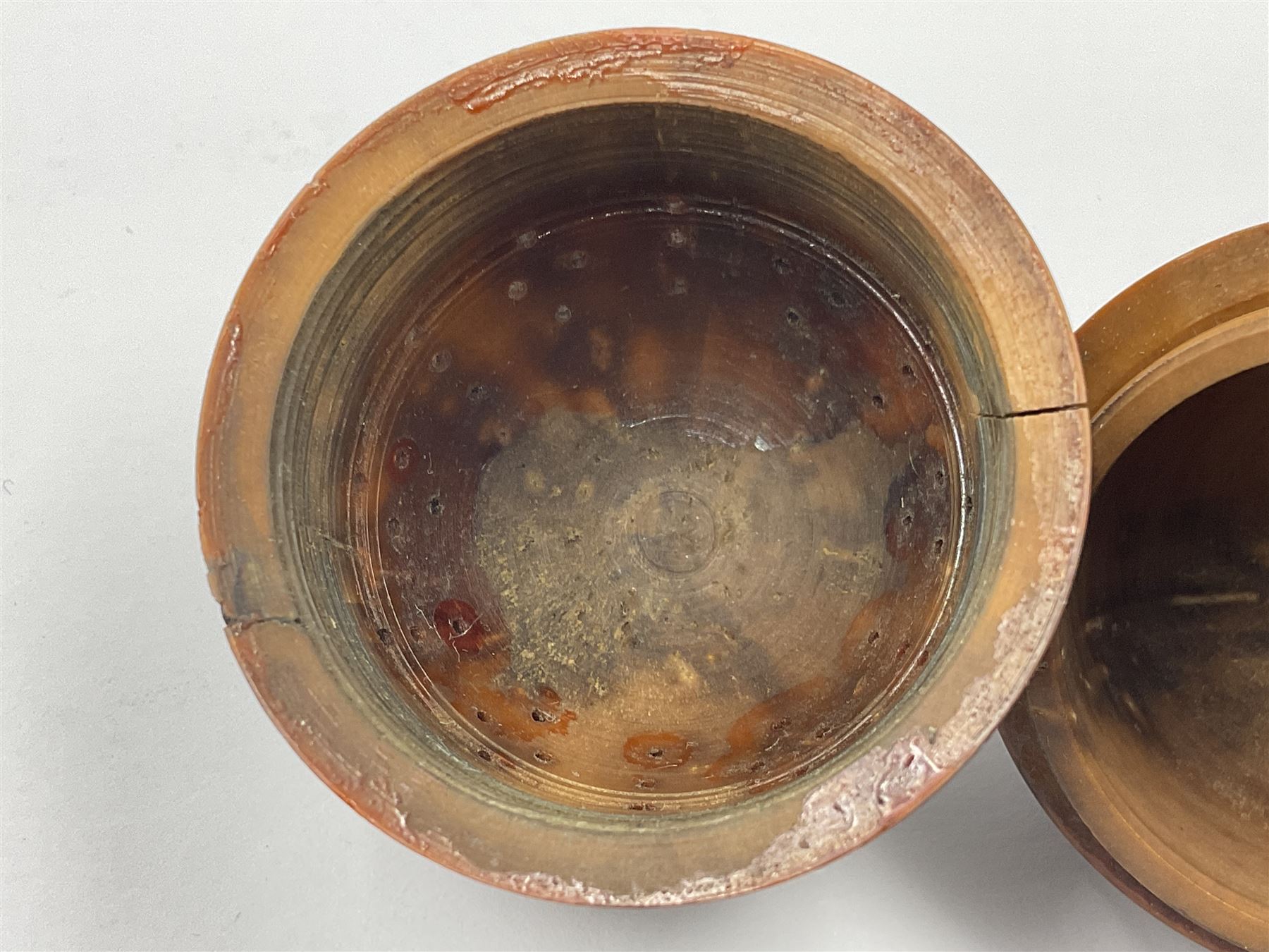 Three 19th century coquilla nut pomanders or flea catchers, two of egg shaped form and the third of barrel from with carved and pierced decoration and screw threaded join, largest H8cm
