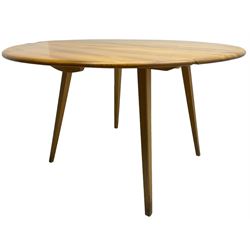 Ercol - mid-20th century golden elm drop-leaf dining table, circular top over splayed supports