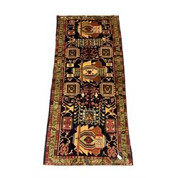 North West Persian Heriz Kelleh rug, the blue ground field with large stylised plant medallions, decorated with flower head, bird and tree of life motifs, triple band foliate pattern borders 