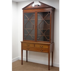  Early 20th century Georgian style mahogany bookcase on stand, broken arched pediment with dentil detail and scrolled inlays, two astragal glazed doors enclosing adjustable shelves, stand with two short and one long drawer, square tapering supports with spade feet, W108cm, H211cm, D39cm  