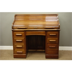  Early 20th walnut roll top desk, serpentine tambour and fitted interior above eight drawers, lock stamped Angus London, W121cm, H115cm, D65cm  