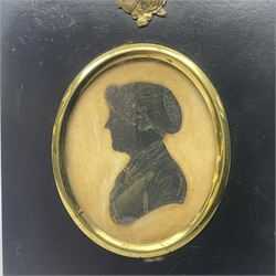 19th century oil on board, depicting an older female in black robes and lace bonnet and collar, in gilt frame, together with three early 20th century and later silhouettes, to include one depicting a side profile of a young female in a fascinator, an older woman in a bonnet and a young gentleman with a ruffle collar, all in black frames, largest frame H16.4cm