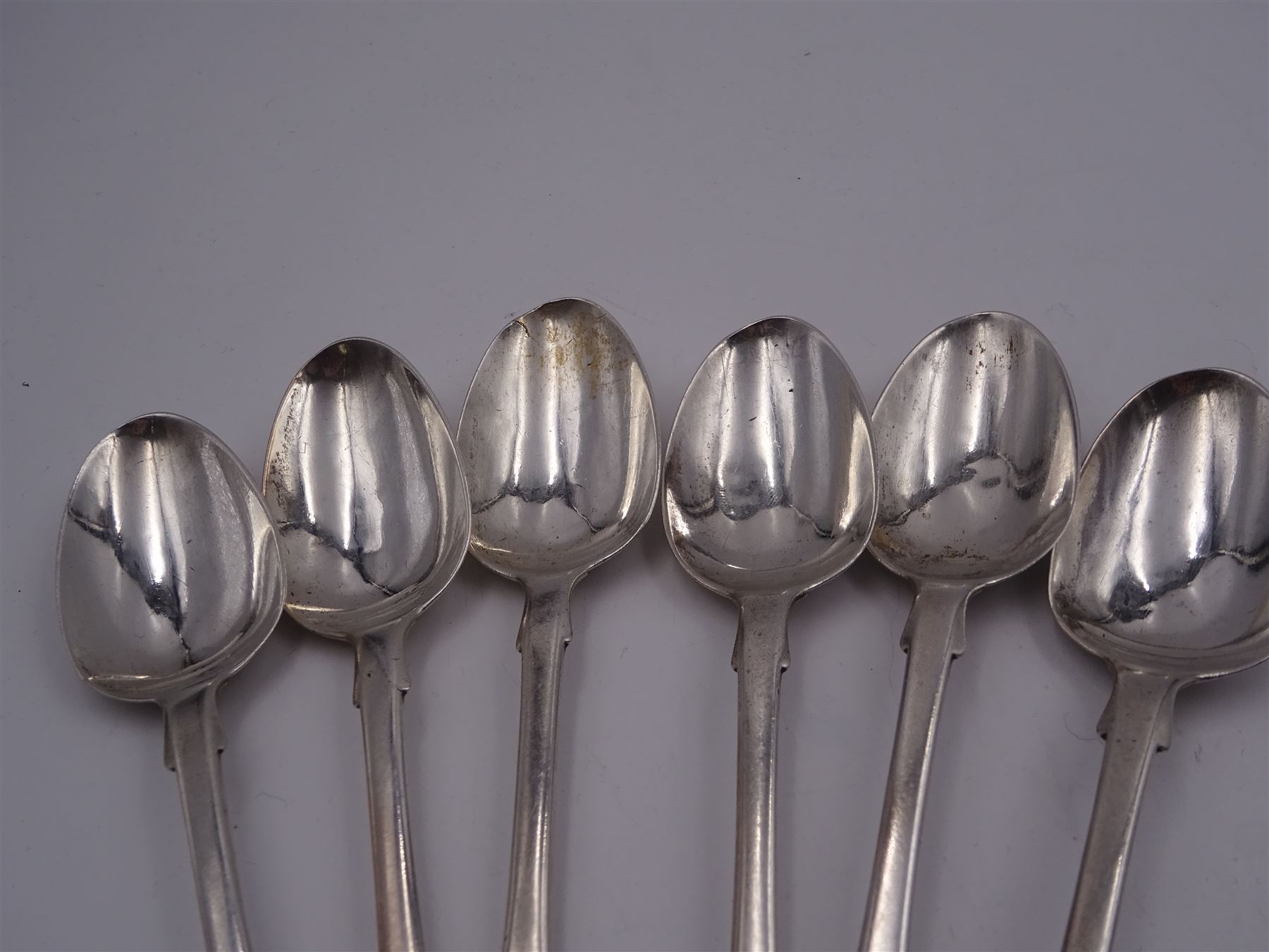 Group of Victorian silver fiddle pattern spoons, comprising pair of sauce ladles and set of six teaspoons, both hallmarked Henry Holland (of Holland, Aldwinckle & Slater), London 1857, set of four table spoons, hallmarked Chawner & Co (George William Adams), London 1857, and set of six dessert spoons, hallmarked Chawner & Co (George William Adams), London 1856, with monogrammed terminals, approximate total silver weight 25.50 ozt (792.6 grams)