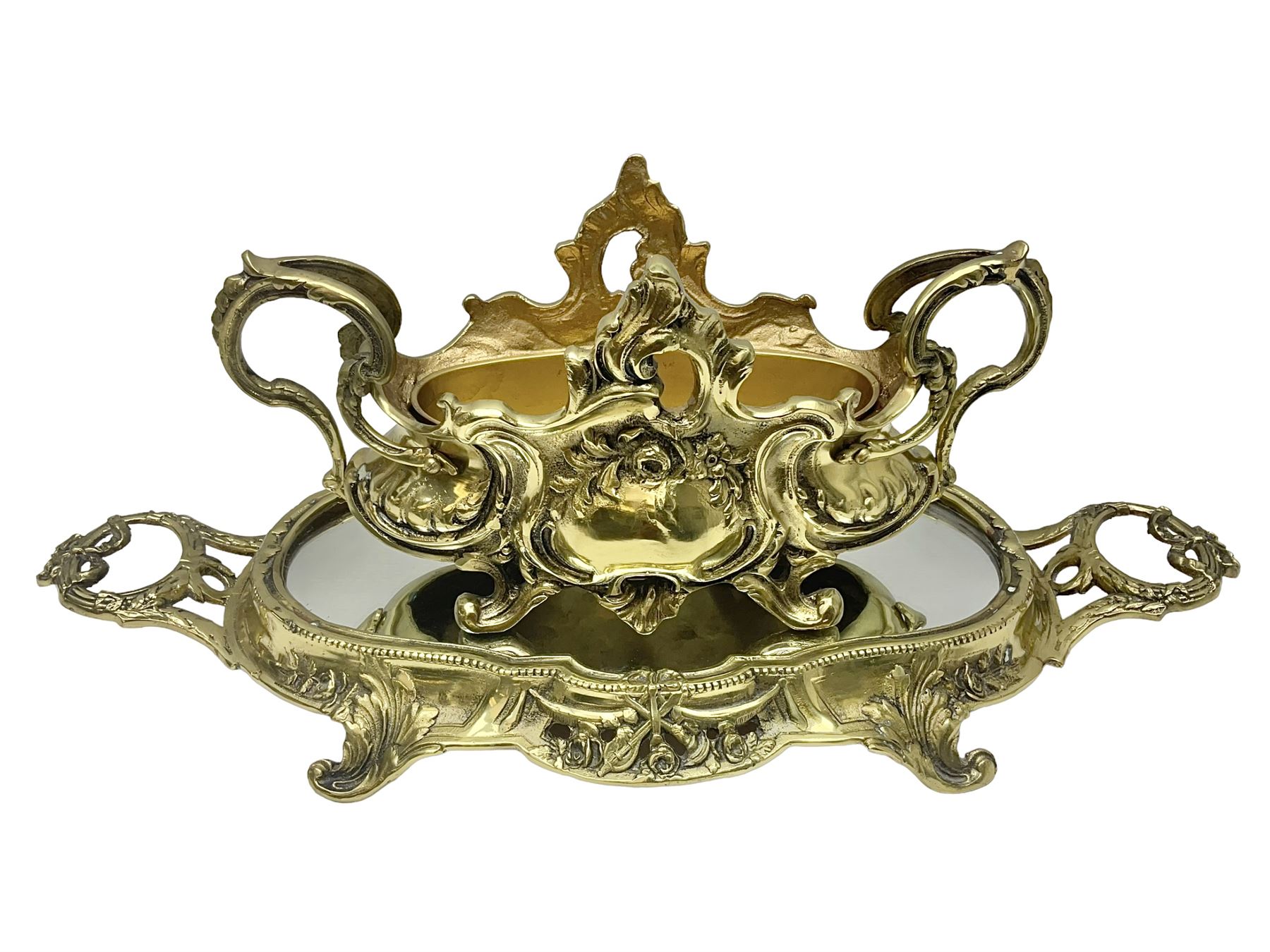 Ornate brass centrepiece, with twin handled vase upon a mirrored base, with floral and scrolling decoration, H23cm 