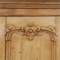 Late 19th century pine wardrobe, with stepped cornice over triple panelled doors, applied foliate carvings to outer panels, raised over a separate pine plinth drawer with moulded facia and twin glass pulls

