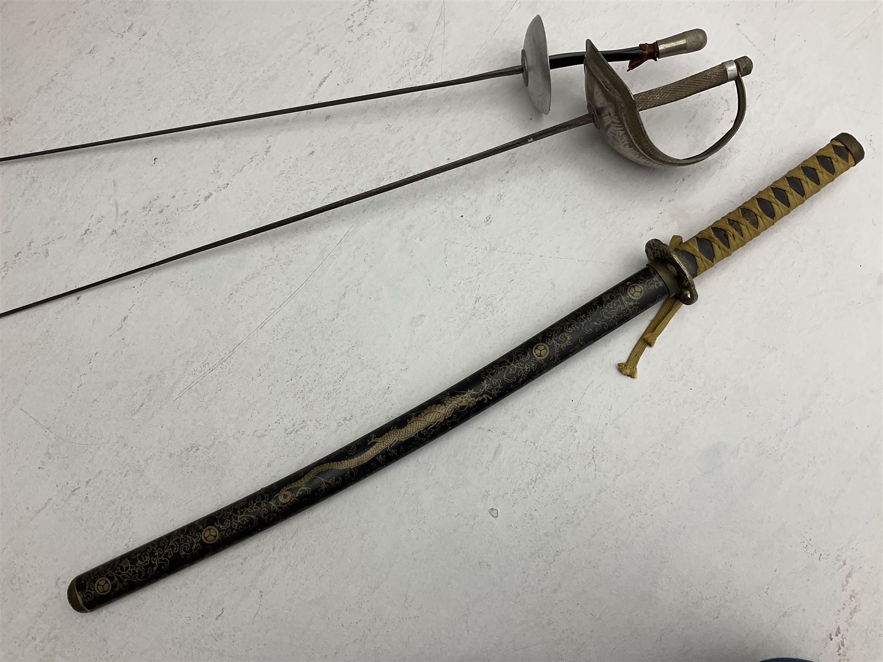 Reproduction Japanese katana with 63cm slightly curving fullered steel blade, ornate tsuba, cord bound grip and gilt transferred black saya L92cm; and two fencing foils, one marked Leon Paul (3)