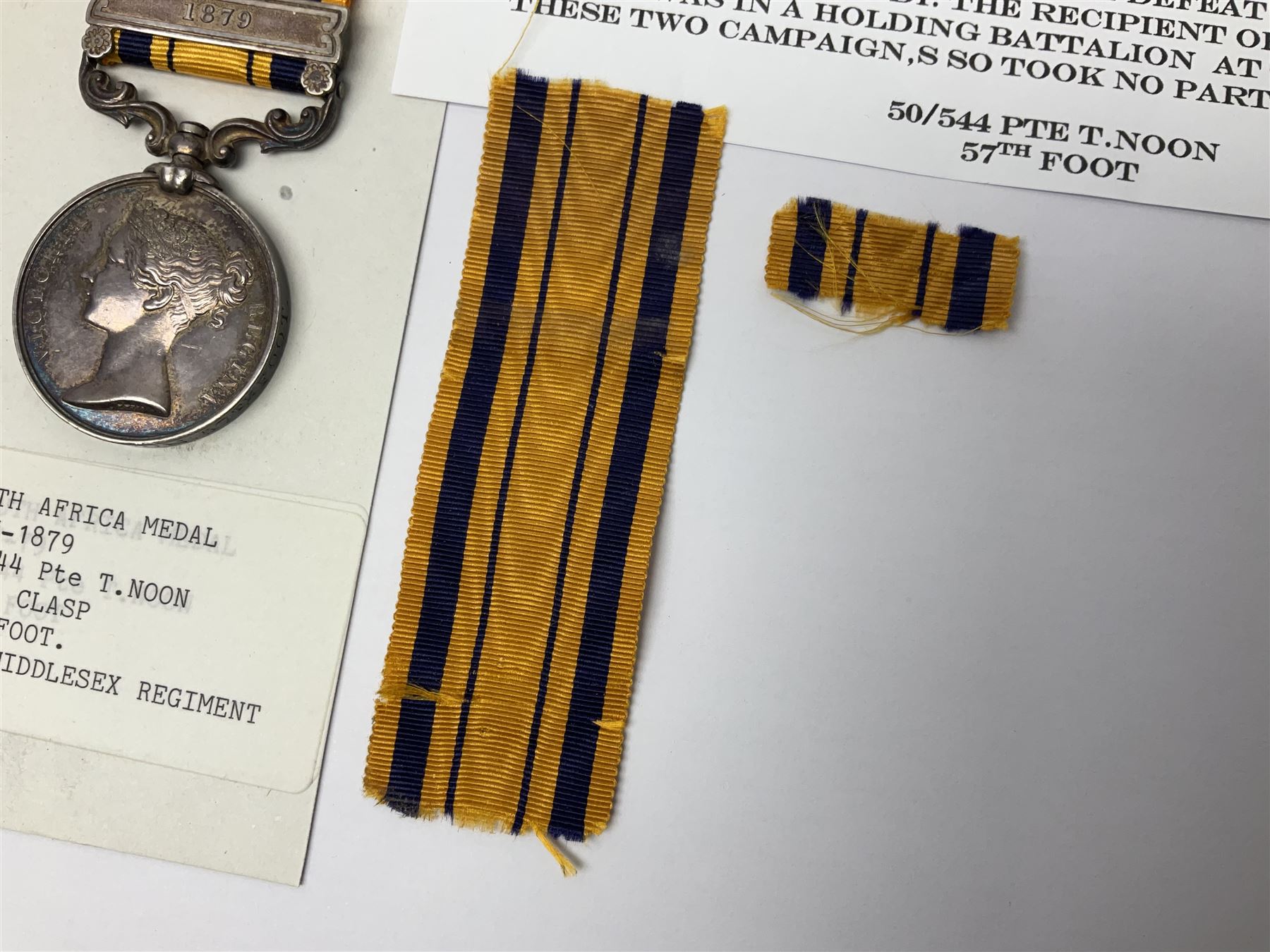 Victoria South Africa Medal (Zulu Wars) 1877-79 with 1879 clasp awarded to 50/544 Pte. T. Noon 57th Foot (West Middlesex regiment); with replacement ribbon but original ribbon present