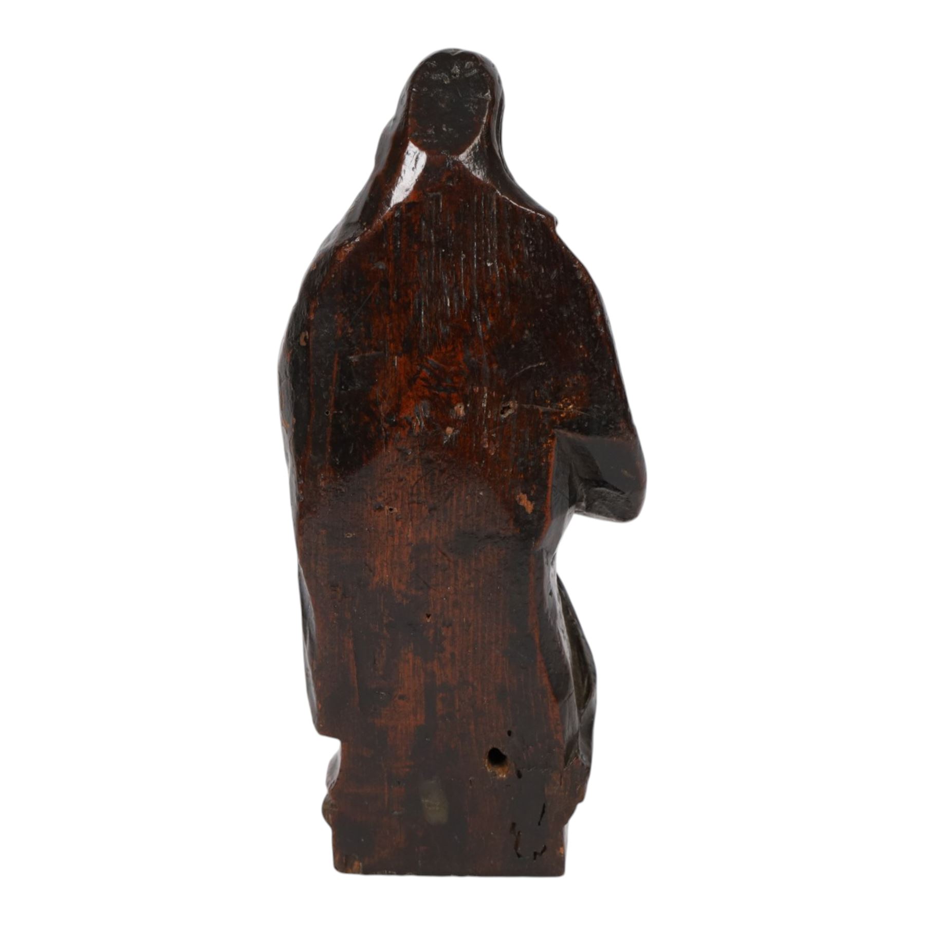 17th century carved limewood figure of a saint, with traces of original polychrome painted decoration, H20.5cm