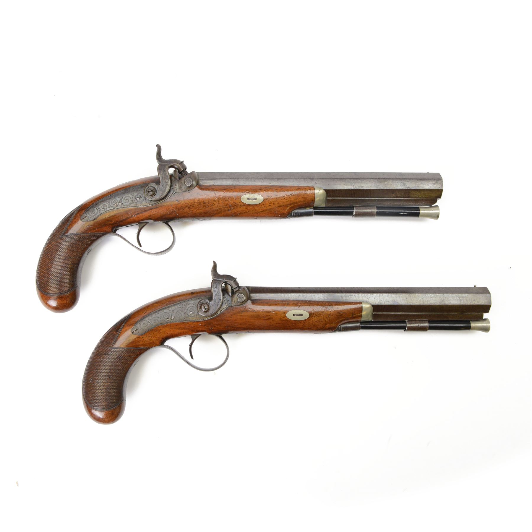 Pair of 19th century officer's duelling pistols, by William Chance & Son, with 25 bore sighted octagonal brown barrels, engraved London to the top, with gilt and platinum lines, foliate engraved tang, the back action lock plate signed and engraved with foliage, the walnut half stock, the trigger guard engraved with foliate and pineapple design, with ebony ramrods, in a brown velvet lined mahogany case, fitted with accessories including a copper pistol flask, a steel bullet mould, a tin of caps, lead balls, a cleaning rod with brass screw top