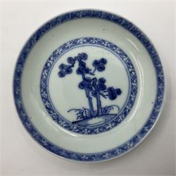 Two Chinese Nanking cargo tea bowls and saucers, circa 1745, the first example decorated with pine tree pattern within diaper borders, the second decorated with pagodas, rocks and trees, diaper borders, all with Christie's The Nanking Cargo sale label to bases, saucer D10cm