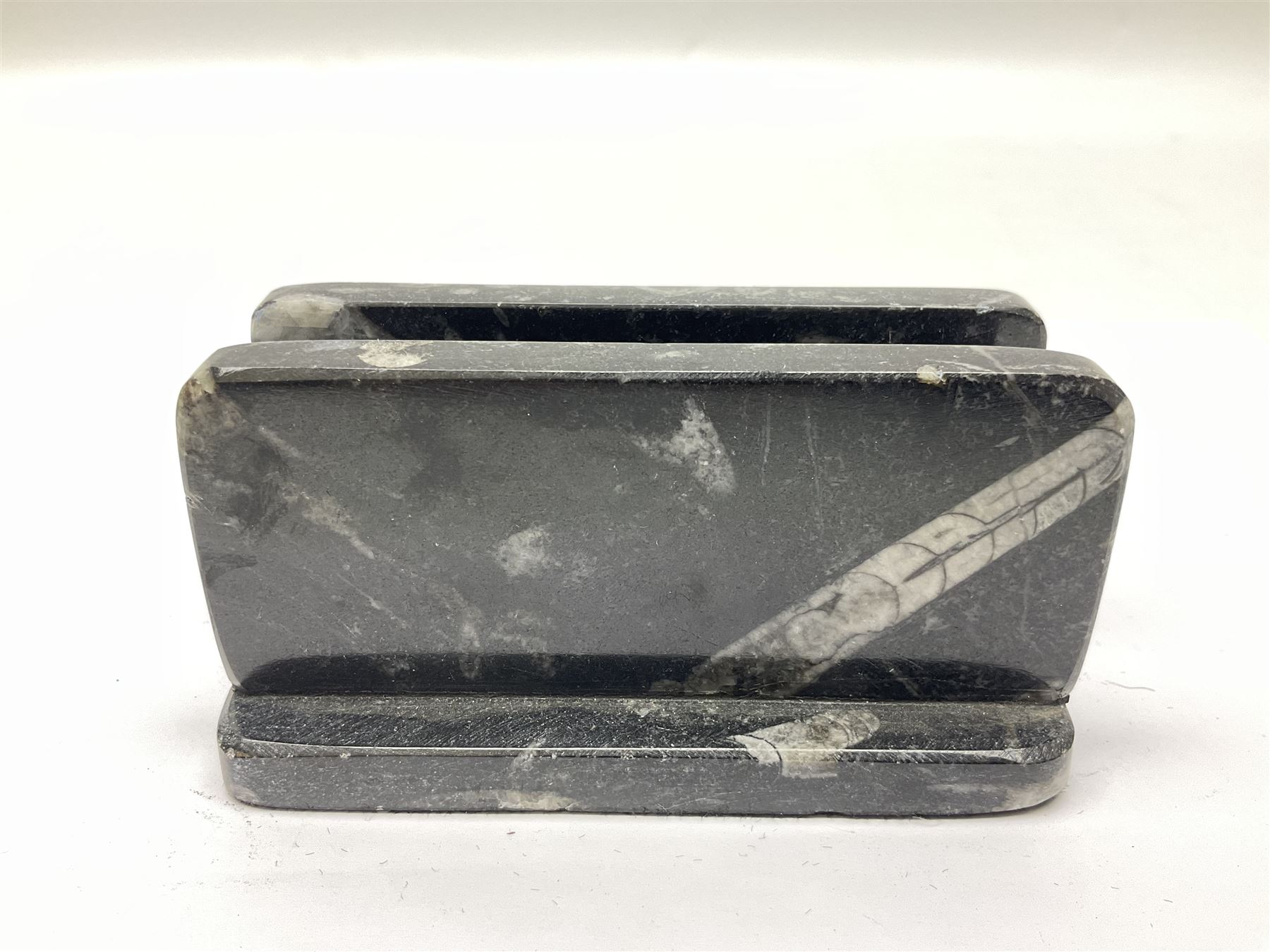 Three piece desk set, comprising letter rack, dish and box with raised Orthoceras to the lid, all with Orthoceras and Goniatite inclusions, age: Devonian period, location: Morocco