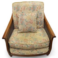Ercol – bergère four piece suite, including armchair, two seat sofa, three seat sofa and footstool, all with removable floral upholstered cushions, the frames with side caning and rounded arm supports in stained beech

Three seat (H 87cm, D 89cm, W 196cm)
Two seat (H 87cm, D 89cm, W 137cm)
Armchair (H 87cm, D 89cm, W 87cm)
Footstool (H 28cm, D 55cm, W 55cm)