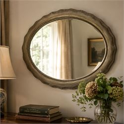 Oval wall mirror, shaped frame with bevelled plate 