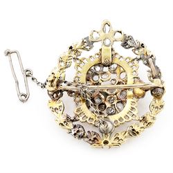 19th century floral spray diamond brooch, three central flower heads set with rose cut and old cut diamonds within an sunburst surround and outer wreath border, set with further rose cut diamonds 