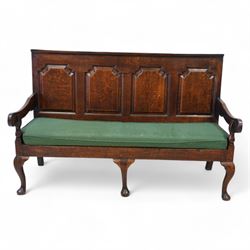 18th century oak settle or hall bench, moulded cresting rail over quadruple fielded panelled back, shaped arms over loose squab cushion upholstered in patterned teal fabric, plain frieze rail over cabriole front supports
