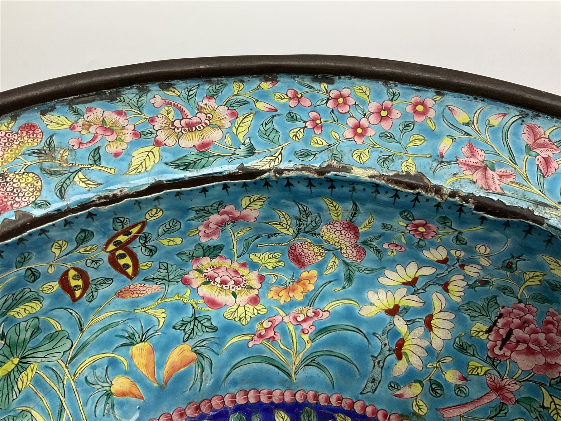 18th/19th century Chinese Canton enamel basin, the circular basin with flat everted rim, decorated with scrolling foliate and fruit decoration on a blue ground, D43cm