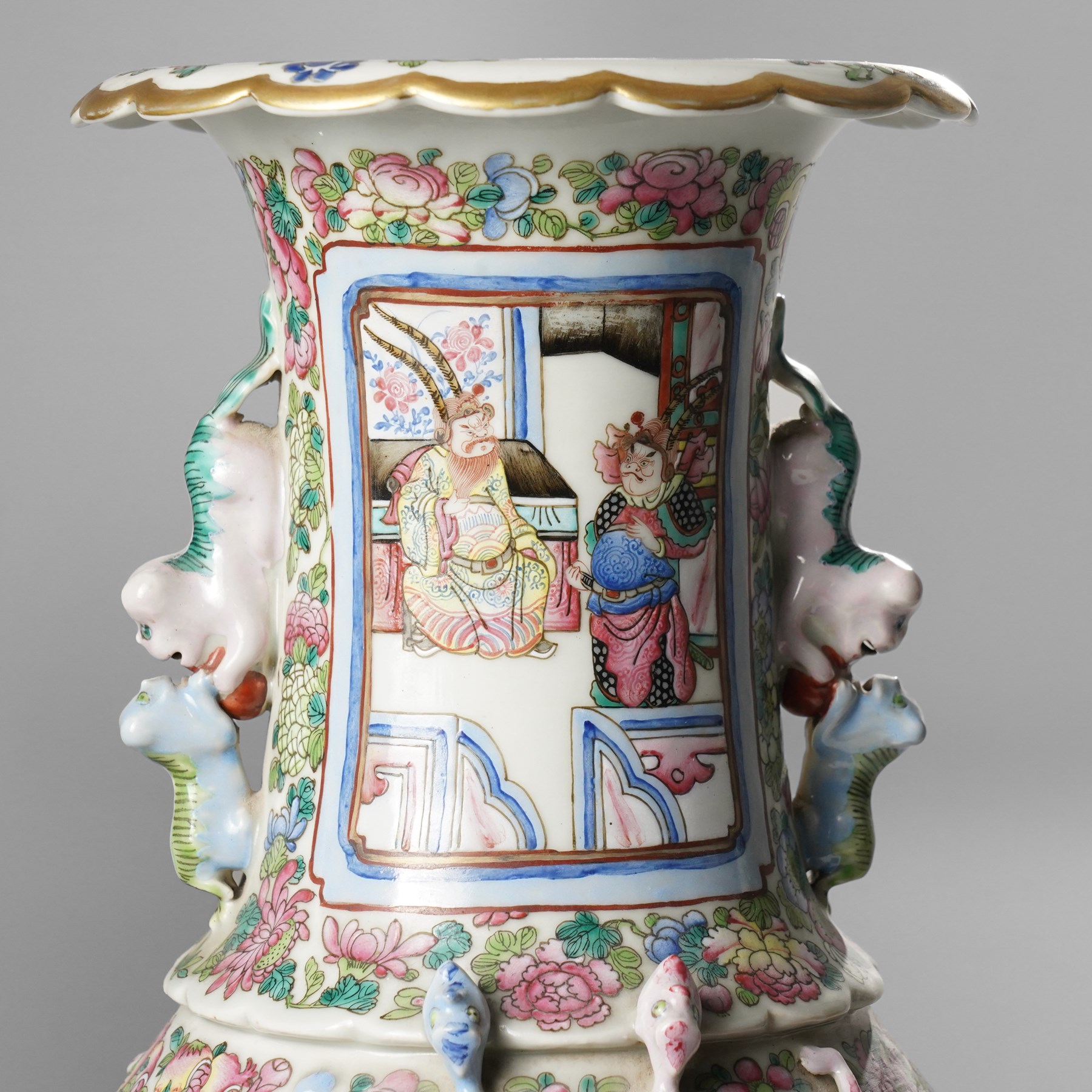 Large pair of 19th century Cantonese famille rose vases, each painted with various courtly scenes, including a display of warriors fighting on horseback before an official and his attendants, double Buddhist lion handles and applied at the shoulders with chilong, the lower band painted with Greek key motif, H58cm (2)