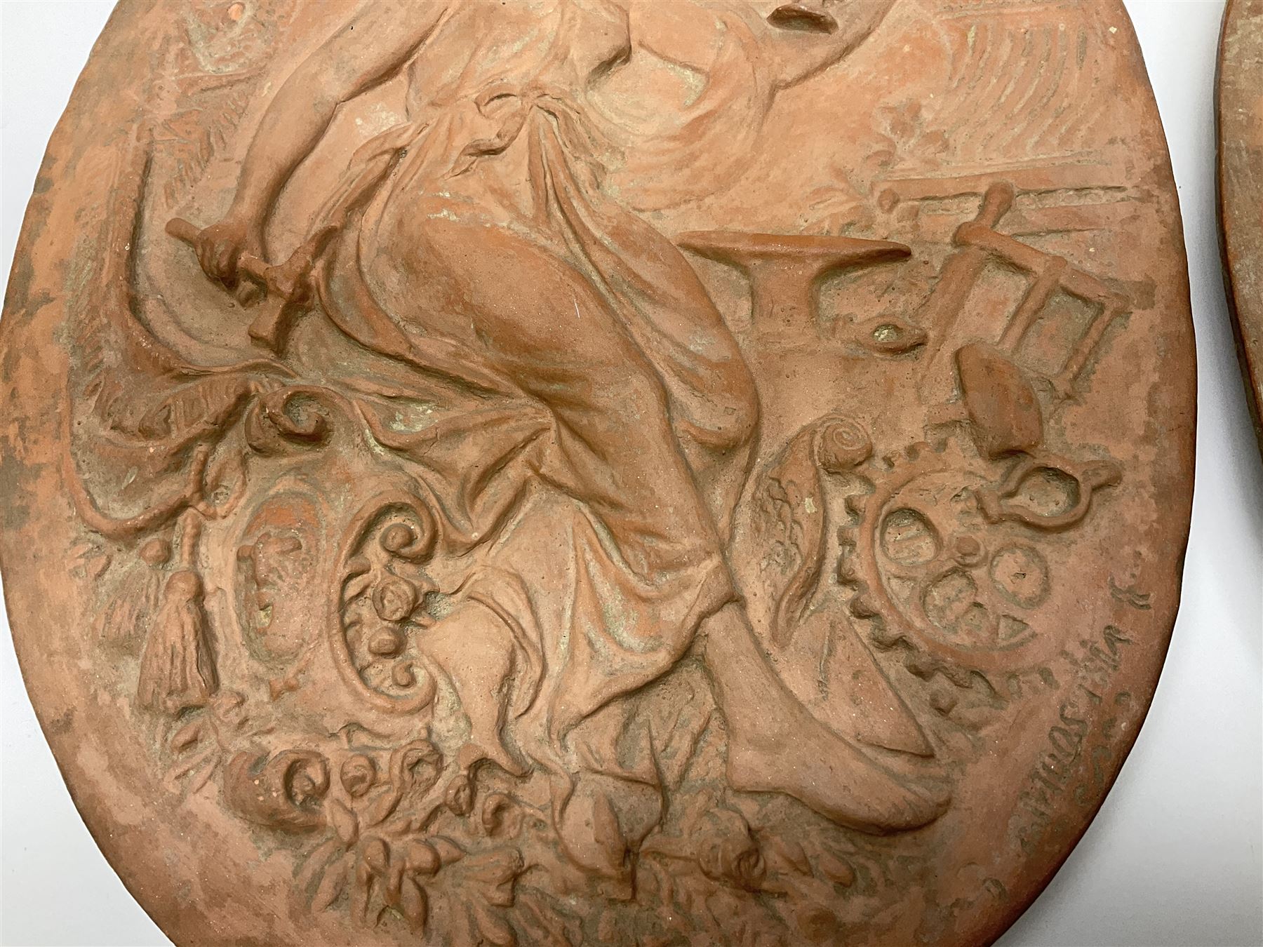 Pair of 19th century classical terracotta relief wall plaques depicting the goddess Hygeia and another goddess, seated holding an ewer, each of oval form, indistinctly signed, each stamped Ferreira verso, H42cm, W30cm