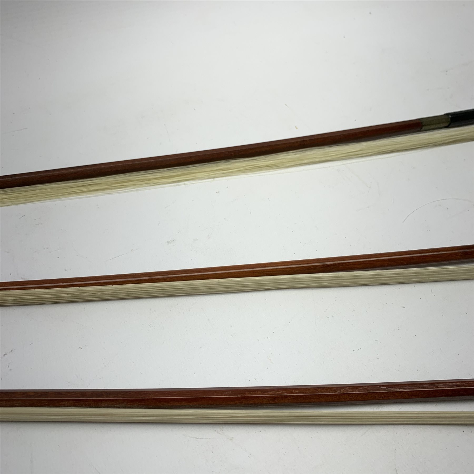 Three pernambuco bows by F.C. Pfretzschner with silver mounts, Adolf Thoma and Tourte