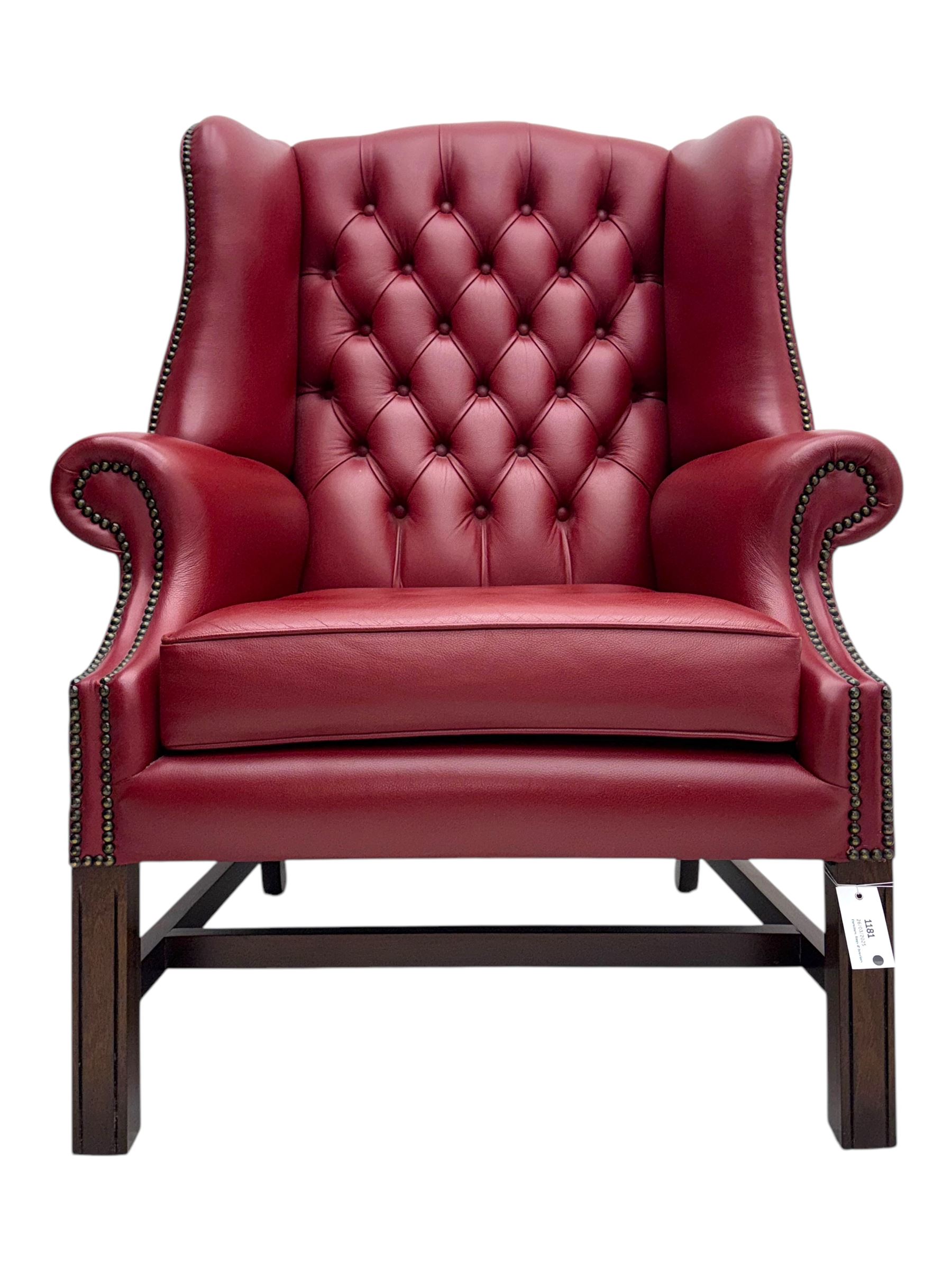 Kingsgate - contemporary 'Suffolk' wingback armchair and matching stool, upholstered in red leather with deep button tufting and brass stud trim, raised on square section supports 