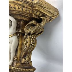 Composite gilded wall bracket shelf, ornately moulded with three putti figures, L42cm