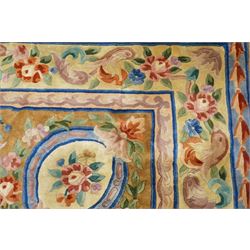 Chinese Aubusson/Savonnerie style hand-knotted carpet, ivory field with a central oval medallion issuing with stylized bouquets in shades of blush pink, pale blue, sage and green, enclosed by ribbon-tied floral garlands and conforming borders within narrow guard stripes, with cotton fringe ends 