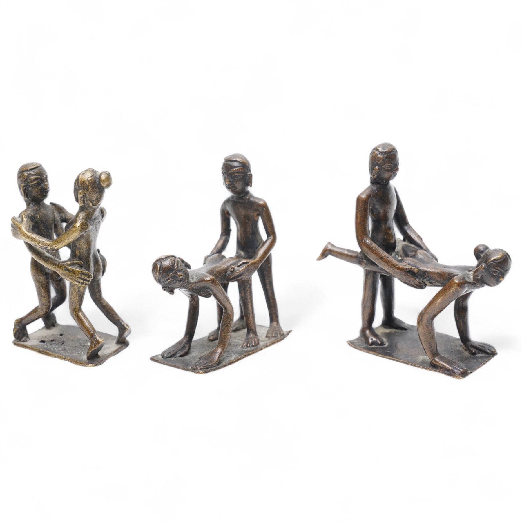 Three Indian school Kama Sutra style erotic bronze figures, H9cm
