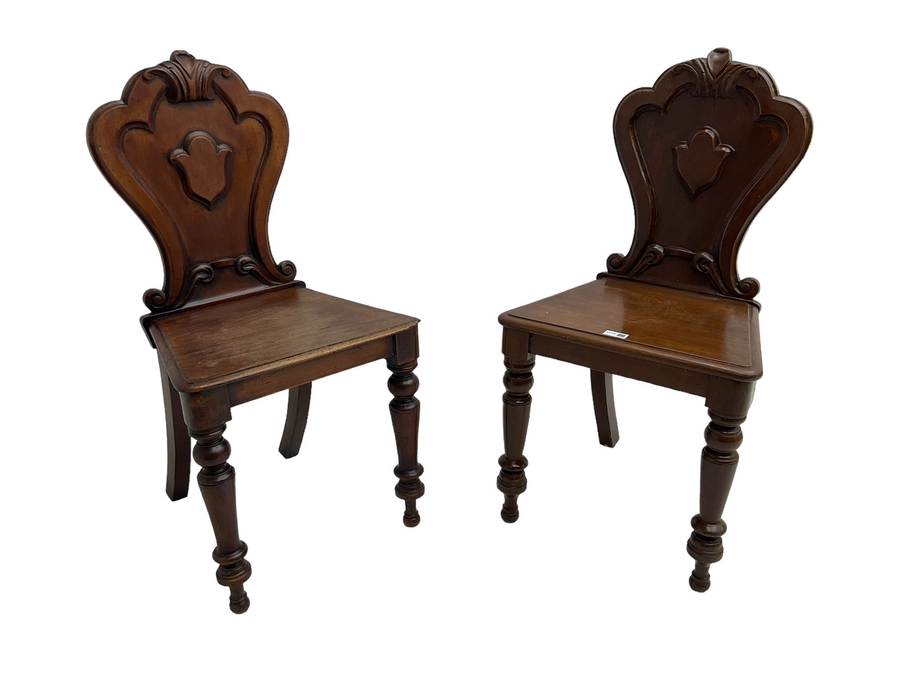 Pair of Victorian mahogany hall chairs, shaped moulded back carved with cartouche, moulded seat on turned front supports
