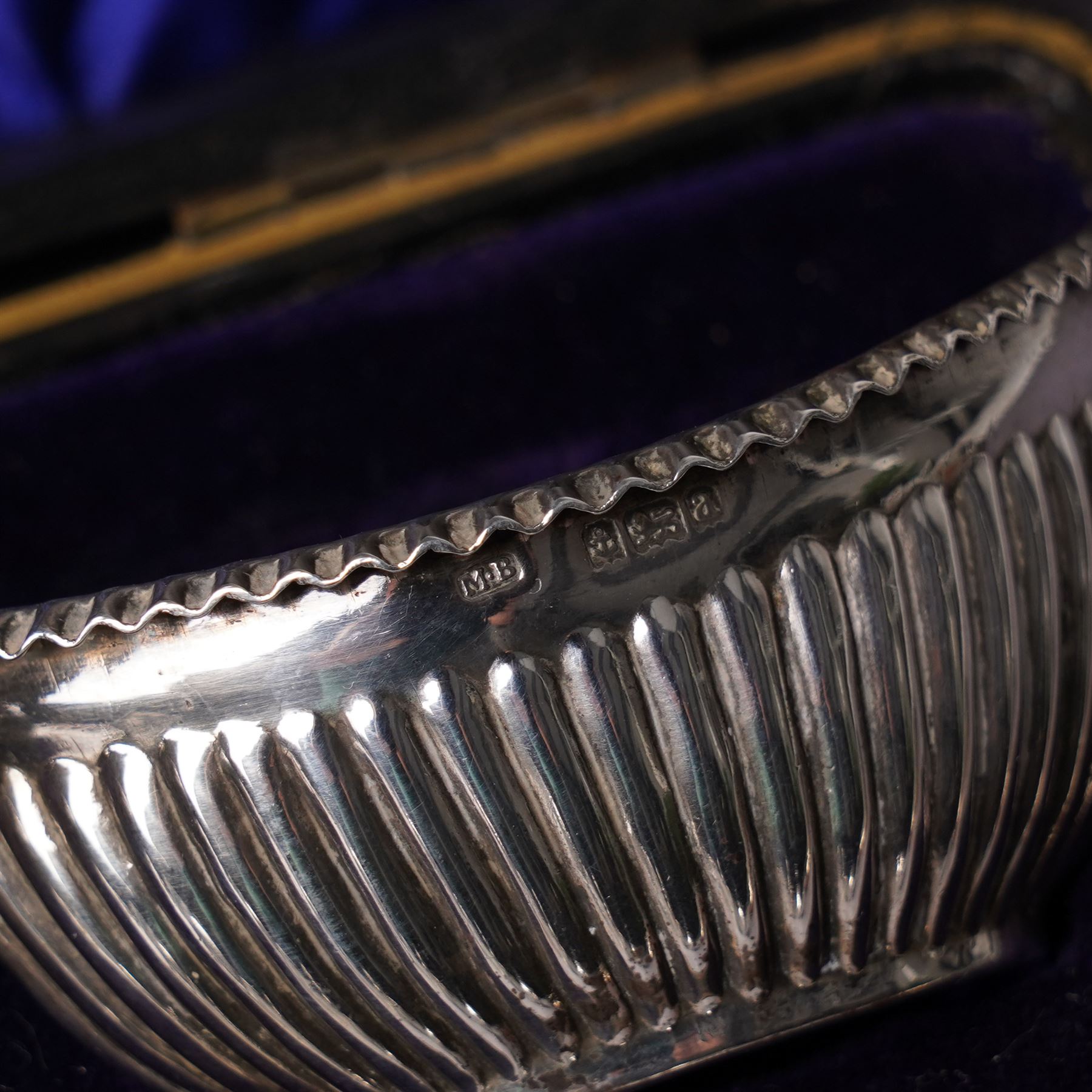 Pair of silver navette shape salts , cased Birmingham 1900 Maker Mitchell Bosley & Co., silver three piece condiment set, pair of silver cornucopia shape salts, silver upright photograph frame 17cm x 13cm and a pair of glass salts with silver rims