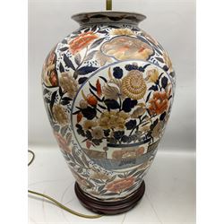 Pair of large and impressive 20th century Japanese Imari table lamps, each of ovoid form, decorated in the Imari palette with roundels containing flowering urns, and shaped panels of birds, set against a white ground decorated with blossoming peonies, lamp base (not including fixtures) H56.5cm overall including shade H89cm