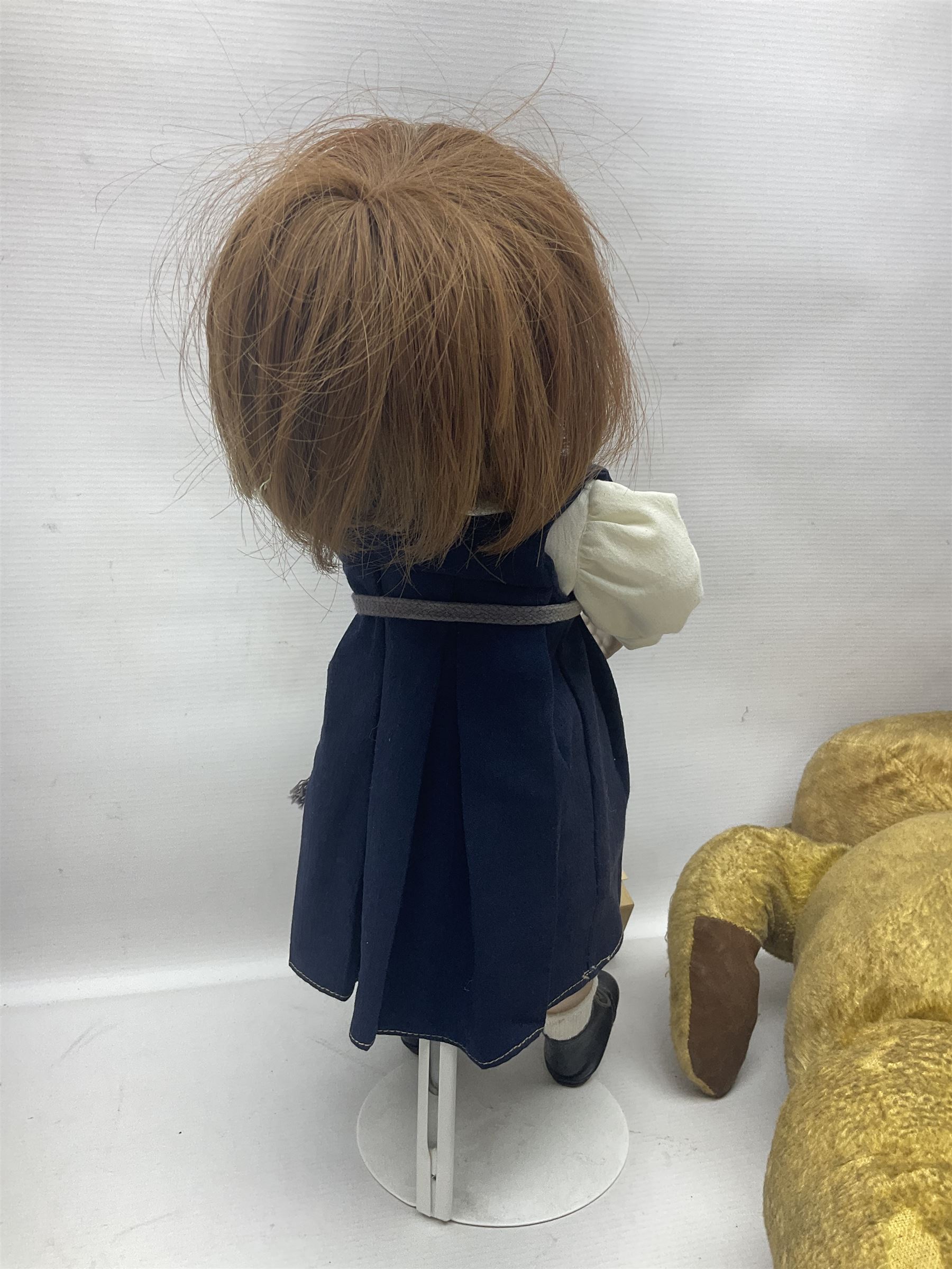 Mid-20th century woodwool filled teddy bear; and porcelain doll dressed as a WW2 evacuee