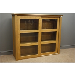  John Lewis light oak cabinet fitted with two sliding glazed doors, W134cm, H113cm, D37cm  