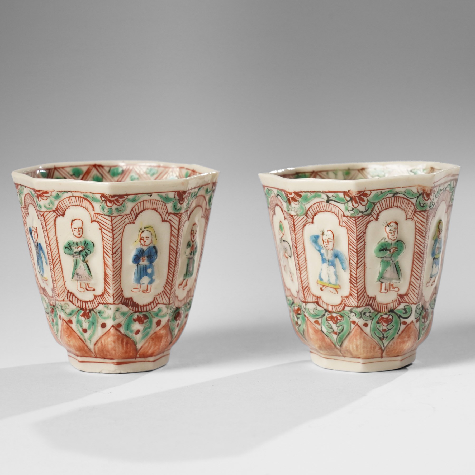 Pair of Chinese Kangxi period Blanc de Chine octagonal 'Immortals' beakers, Dehua, enamelled in Europe, Shi Zhongtun mark to base, H6.5cm (2)