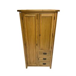 Solid light oak combination wardrobe, fitted with one cupboard enclosing hanging rail, the shorter cupboard above three drawers, on tapered feet
