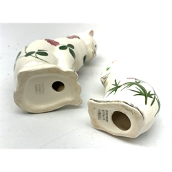Two Plichta pottery cat figures, the largest example hand painted with clover leaves and flowers, with printed mark beneath, H14cm, the smaller example hand painted with thistles, with printed mark beneath, H8cm. 