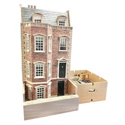 'The Hollies' - good quality sectional wooden doll's house in the form of a Georgian style four-storey bay windowed town house with simulated brick front elevation, rendered sides, off-set corner stonework, faux slate-hung top floor with flat roof and chimney stack, working sash windows, iron railings around front basement courtyard with hinged front elevation to two rooms with  spiral staircase, side hinged central section approached by external steps with iron balustrades to the sides leading to a front door, entrance hall with stairs to landing and two rooms on two floors with dado panelling and fire-surrounds, the top floor with top hung front elevation revealing stairs to a landing and bedroom; wired for electricity L51cm D65cm H107cm including chimney; together with a good quantity of quality wooden furniture and accessories including piano, dressers, bookcase and books, rugs, double half-tester bed, metalware, pictures etc