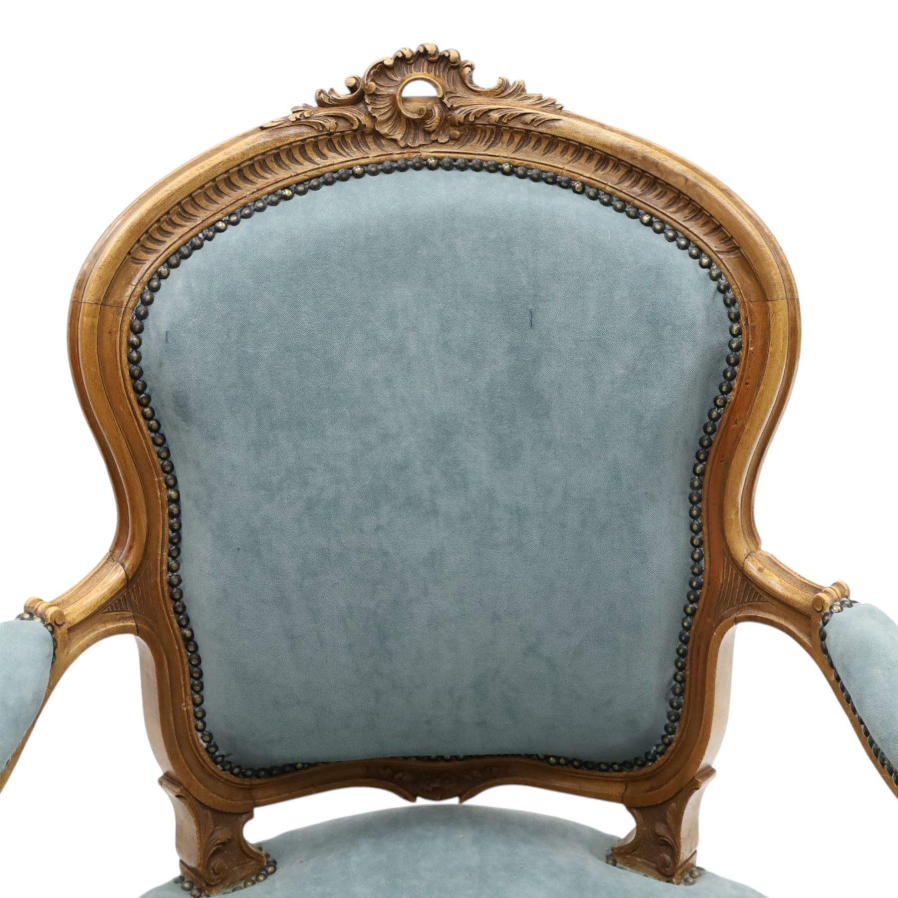 Louis XV design giltwood open armchair, shaped upholstered back with carved foliate cresting, padded scroll arms and serpentine seat upholstered in pale blue fabric with studwork, moulded and foliate carved frame, on cabriole supports with scroll feet