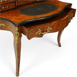 19th century French inlaid figured walnut and ebonised Bonheur de Jour or writing desk, the raised upper section with pierced brass three-quarter gallery, over a mirror glazed cupboard and a combination of drawers, the shaped and moulded top with leather inset and satinwood stringing, with brass beading too the ebonised edge, fitted with a serpentine fronted frieze drawer, raised on cabriole supports, inlaid throughout with scrolling foliate decoration in boxwood and ornate cast brass mounts and handles