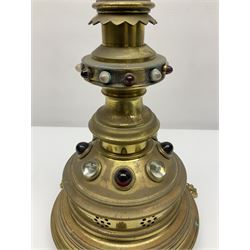 Brass alter cross, decorated with glass cabochons, upon a acicular stepped base and three claw feet, H73cm 