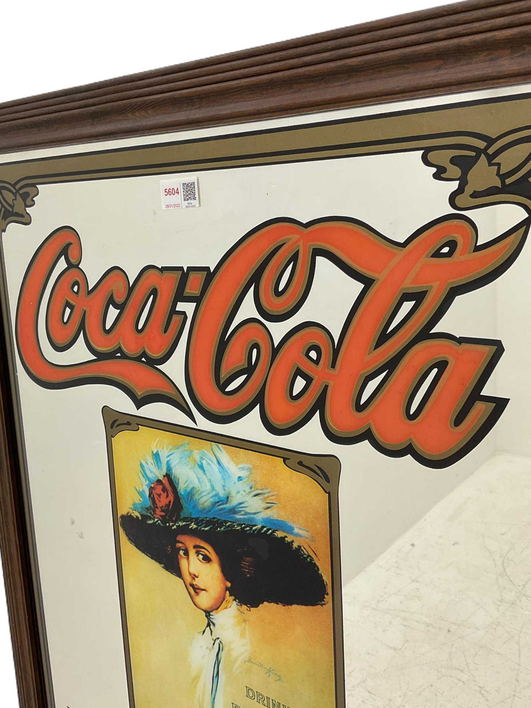 Late 20th century 'Coca Cola' style mirror (64cm x 89cm), and a 20th century frameless mirror (44cm x 67cm)