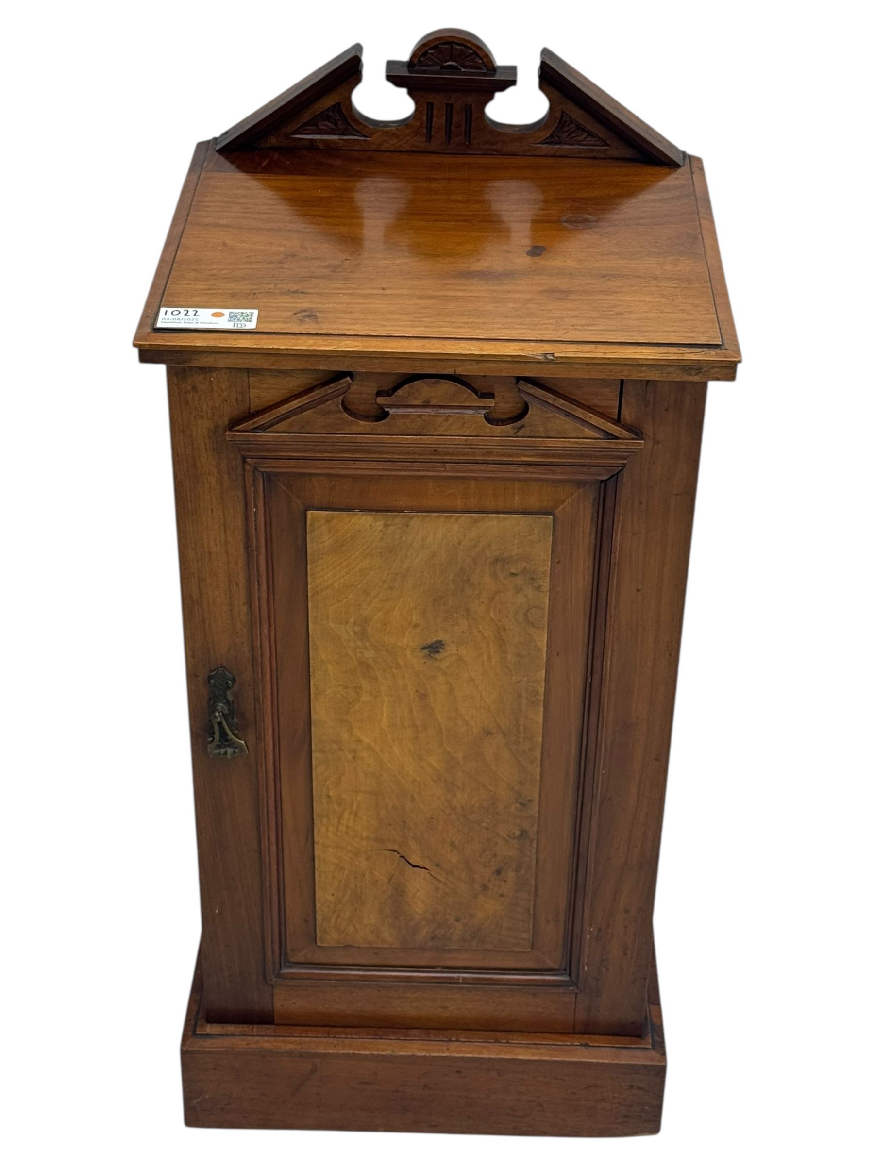 Victorian walnut bedroom suite - wardrobe, dressing chest and bedside cupboard, comprising a full-length wardrobe with broken pediment and central mirrored door, large lower drawer, a matching dressing table with bevelled swing mirror over two trinket drawers and two short drawers over two long drawers, and a single-door bedside cupboard, all with moulded edges, decorative panel work and shaped aprons