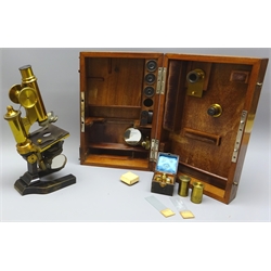  Late 19th century brass monocular Microscope, by E. Leitz Wetzlar No.8240 with rack & pinion coarse and fine adjustment, on black japanned horseshoe base, in original numbered fitted case with three Objective and four Ocular lenses, additional mirror and other accessories, case W40cm, D12.5cm, H31cm max    